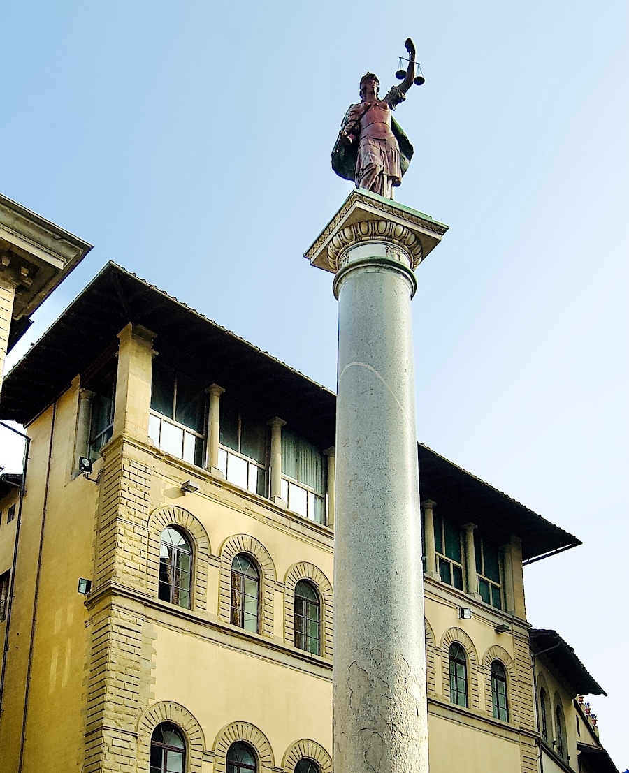 The Column of Justice (Colonna della Giustizia), a Roman granite monolith topped by a porphyry figure of Justice, with Palazzo Buondelmonti behind colonna-della-giustizia.jpeg